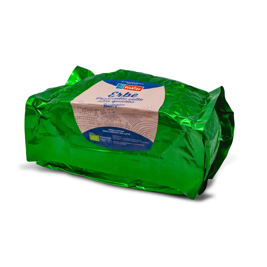 A package of Dalla Costa pasta labeled "Erbe" in a shiny green wrapper. The label indicates the pasta is made with aromatic herbs. The packaging features illustrations of basil leaves and cityscapes in a light beige tone.